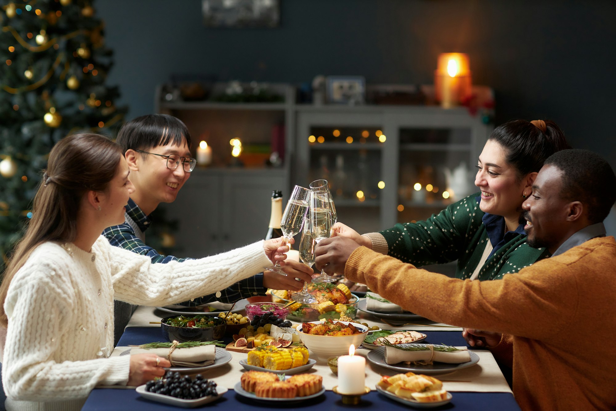 People Raising Toast at Table while Celebrating New Year at Home